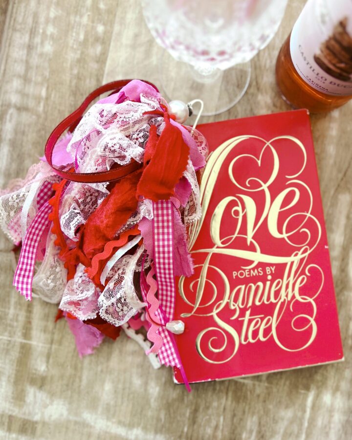 bookmark tassel with ribbonsthat's hanging outside of a book with wineglass and winebottle at the top